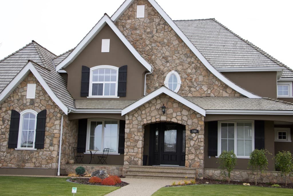 Value Windows technician handling a new triple-pane window unit at a Calgary project staging area