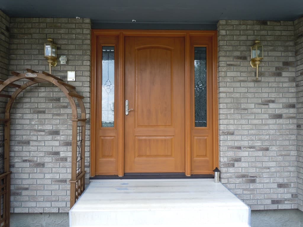 Value Windows technician surveying a home exterior before a window replacement project in Alberta