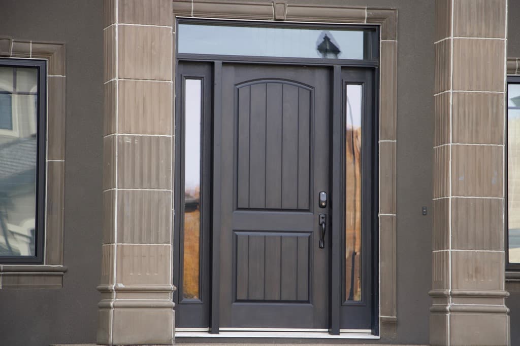 Two-person Value Windows crew installing windows on the second floor of an Alberta home